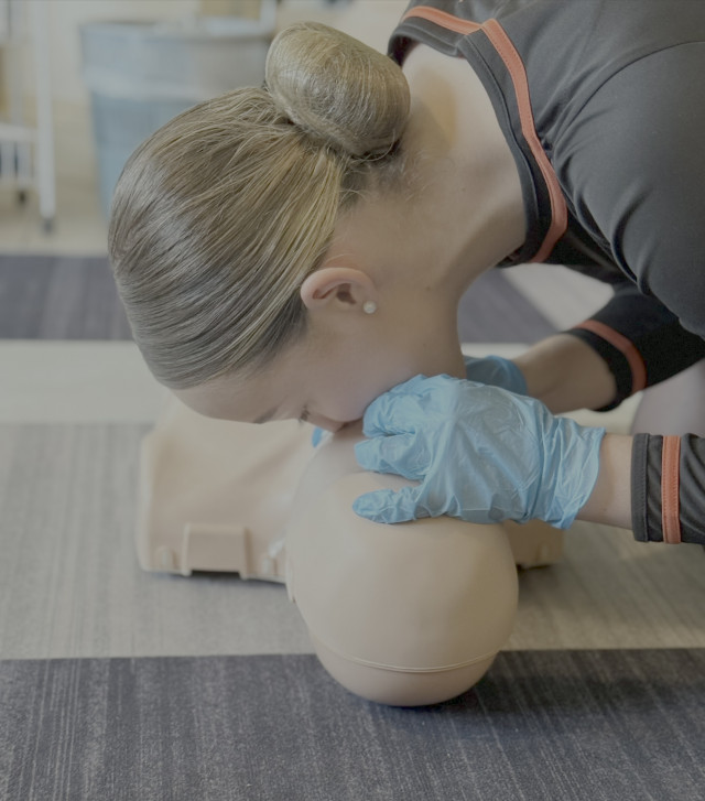 A student demonstrating rescue breaths during a First Aid course at Stay Calm Training